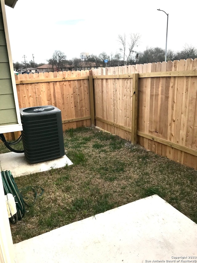 view of yard with a patio and central air condition unit