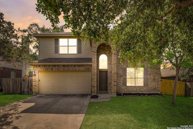 view of front of home featuring a yard and a garage