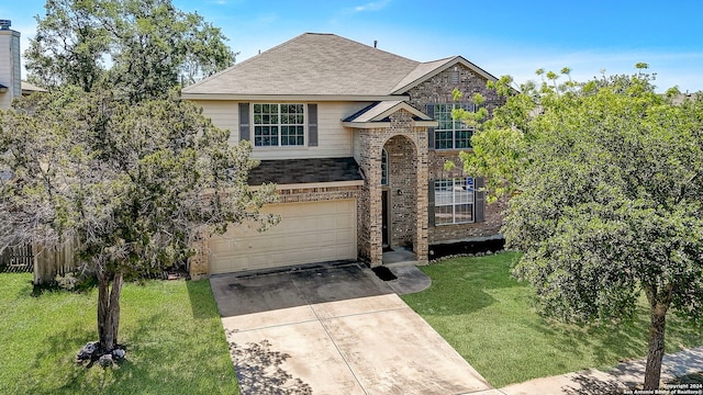 view of front of home with a front yard and a garage