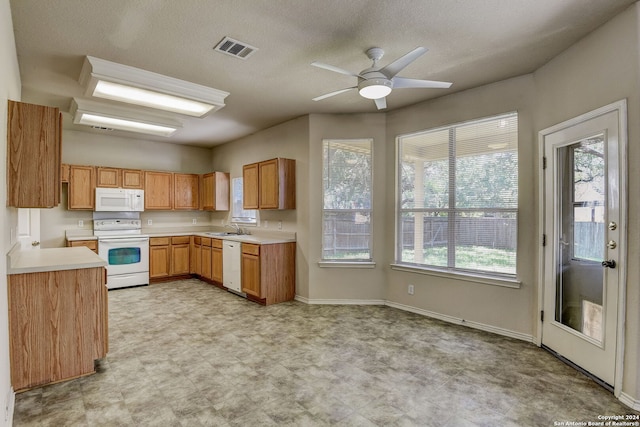 kitchen with white appliances, ceiling fan, sink, and light tile floors