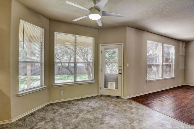 entryway featuring a textured ceiling, ceiling fan, and light tile floors