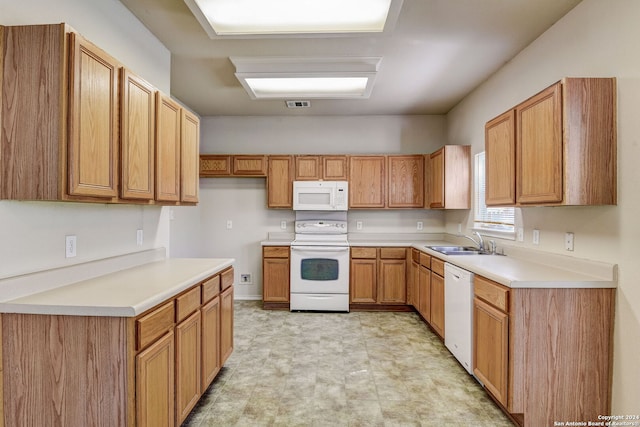 kitchen featuring white appliances, sink, and light tile floors