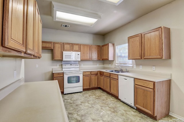 kitchen with sink, white appliances, and light tile floors