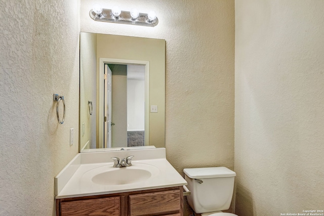 bathroom with oversized vanity and toilet