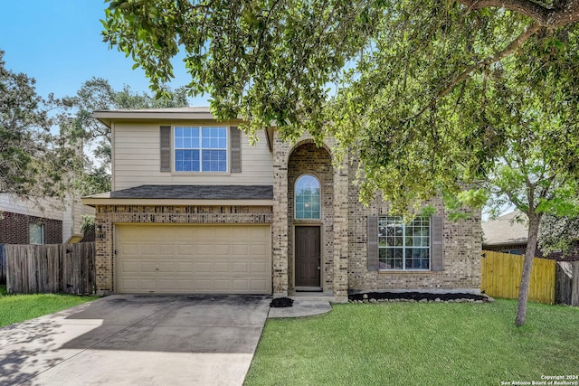 view of front property with a garage and a front yard