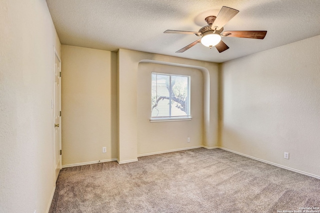 carpeted empty room with a textured ceiling and ceiling fan