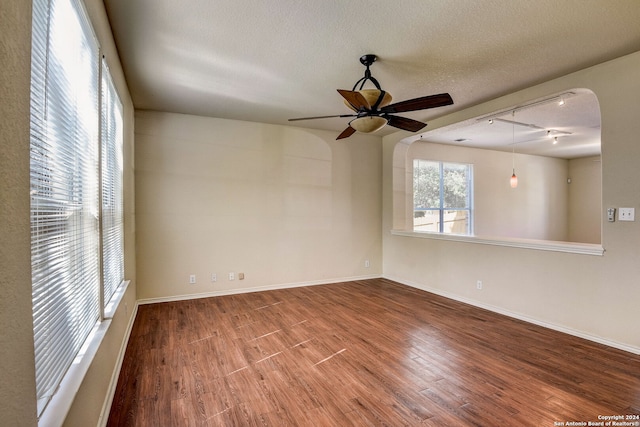 unfurnished room featuring ceiling fan, light hardwood / wood-style flooring, and a textured ceiling