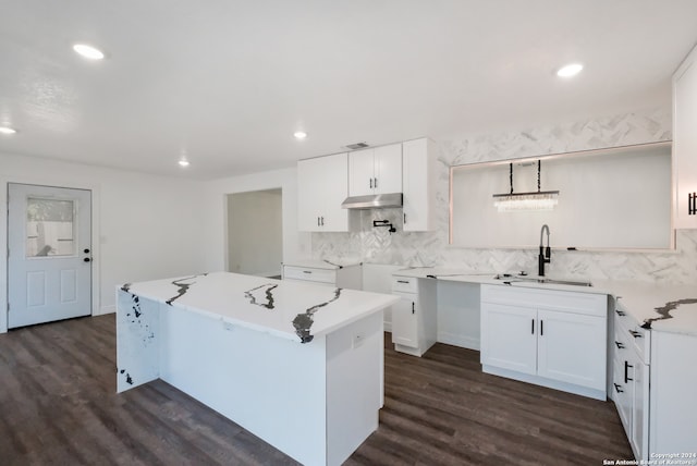 kitchen with a center island, sink, tasteful backsplash, white cabinetry, and dark wood-type flooring