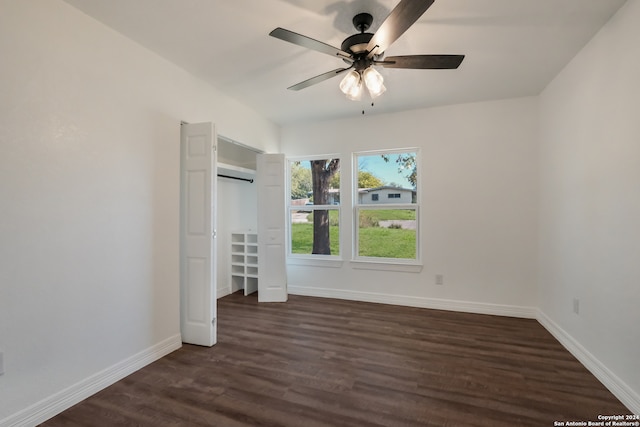 unfurnished bedroom featuring a closet, ceiling fan, and dark wood-type flooring