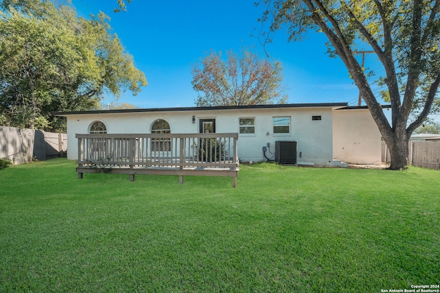 back of house with a lawn, a wooden deck, and central AC unit