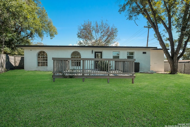 rear view of property with a lawn