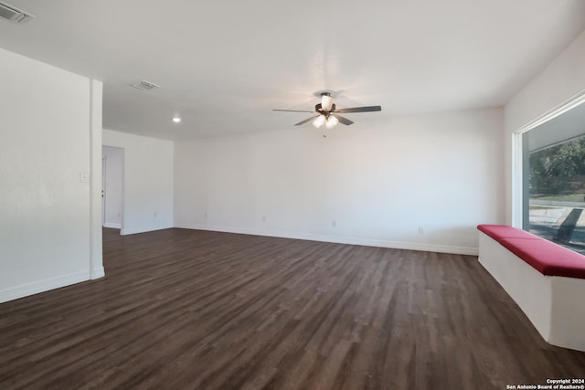 spare room with ceiling fan and dark wood-type flooring