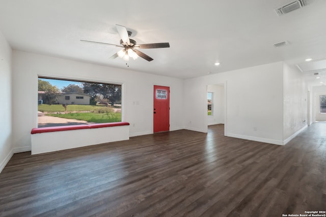 spare room with dark wood-type flooring and ceiling fan