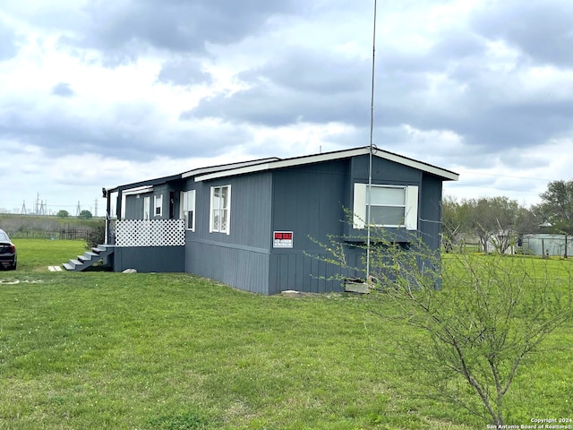 view of side of property with a lawn