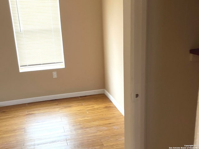 unfurnished room with light wood-type flooring