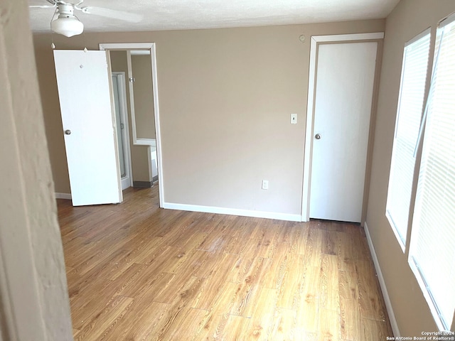 unfurnished room featuring light hardwood / wood-style floors and ceiling fan