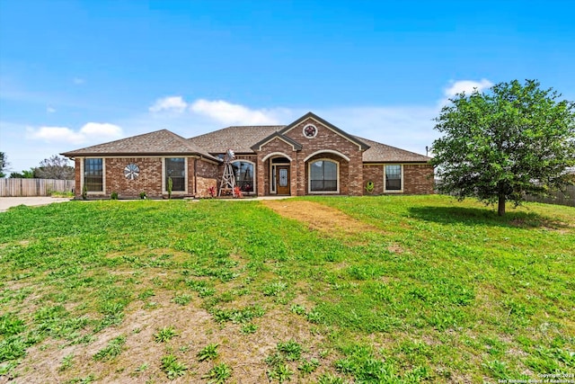 single story home featuring a front yard