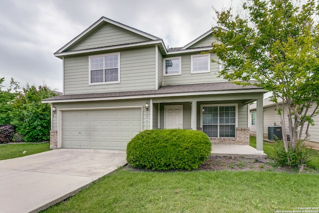 view of front of property featuring central AC, a garage, covered porch, and a front yard