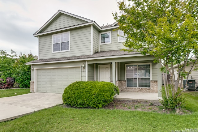 view of front of home with central AC unit, a front lawn, and a garage