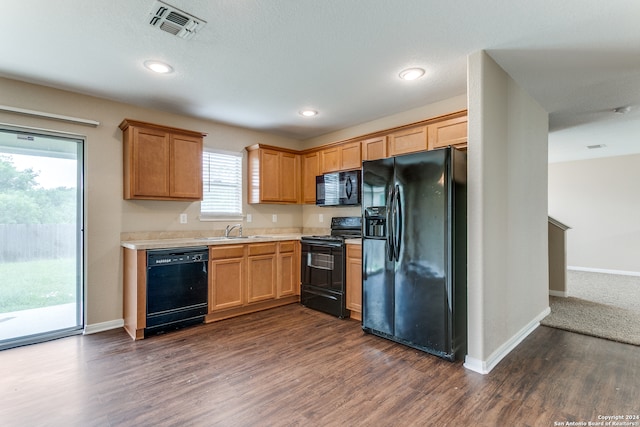 kitchen featuring sink, black appliances, and dark hardwood / wood-style floors