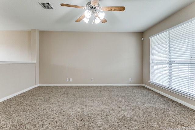 unfurnished room with light colored carpet and ceiling fan