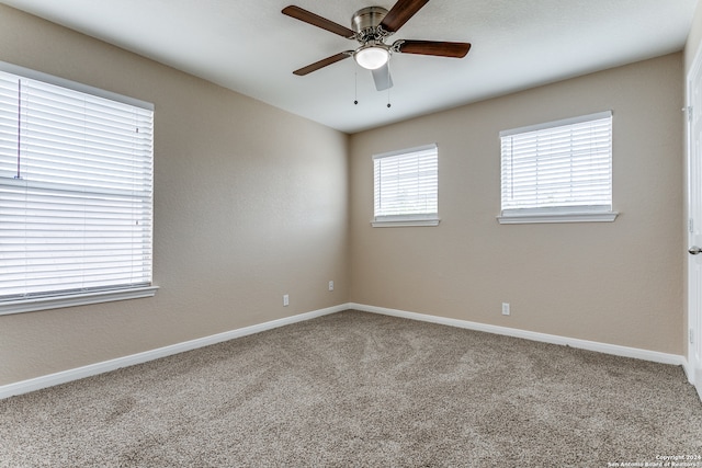 carpeted empty room with ceiling fan