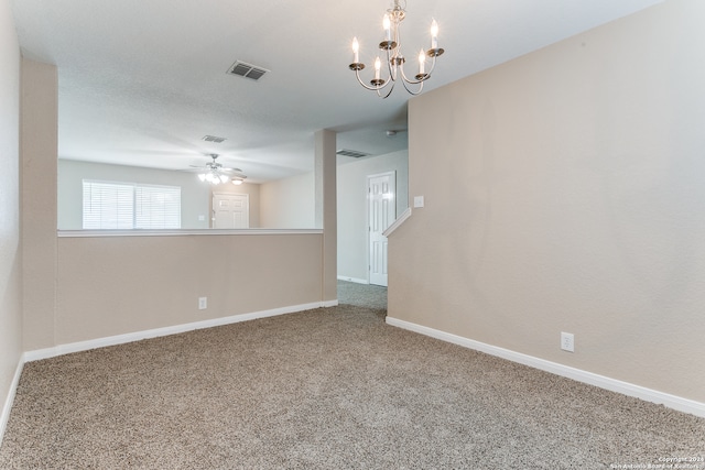 unfurnished room featuring ceiling fan with notable chandelier and light carpet