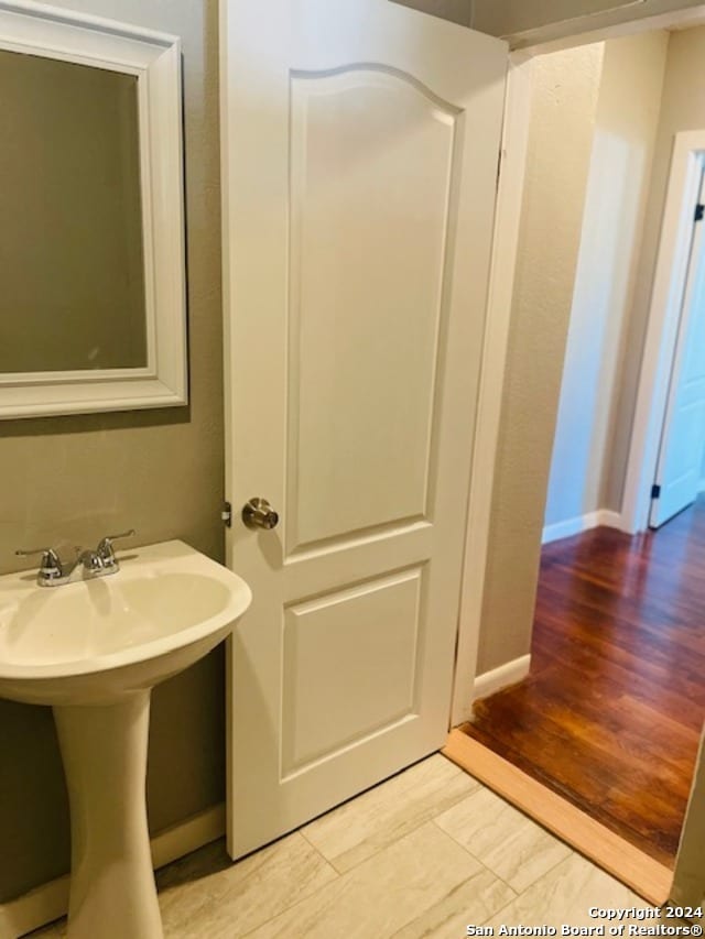 bathroom with sink and wood-type flooring