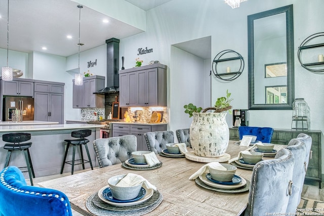 dining space with a towering ceiling