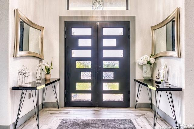 entryway featuring french doors and light wood-type flooring