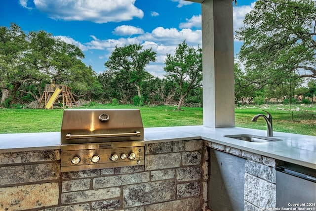 view of patio with sink, a grill, and a playground