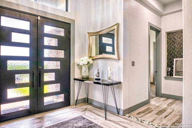 entrance foyer featuring light hardwood / wood-style flooring and french doors