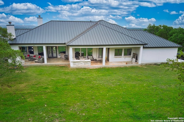 back of house with a patio and a yard