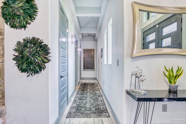 corridor with light hardwood / wood-style floors