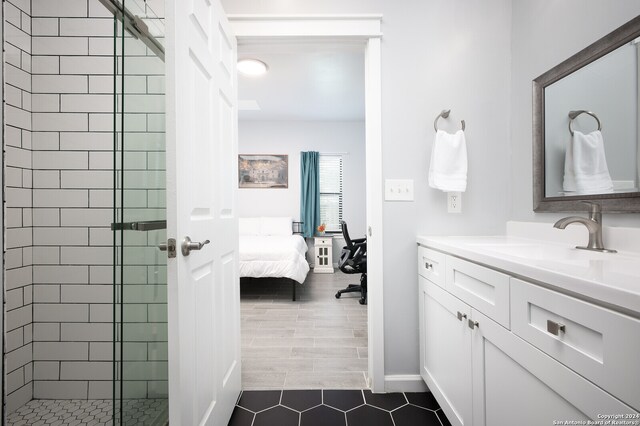 bathroom featuring tile floors, vanity, and a tile shower