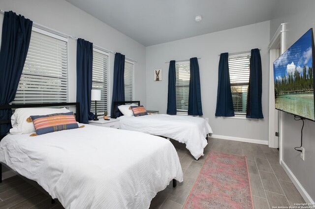 bedroom with dark hardwood / wood-style flooring