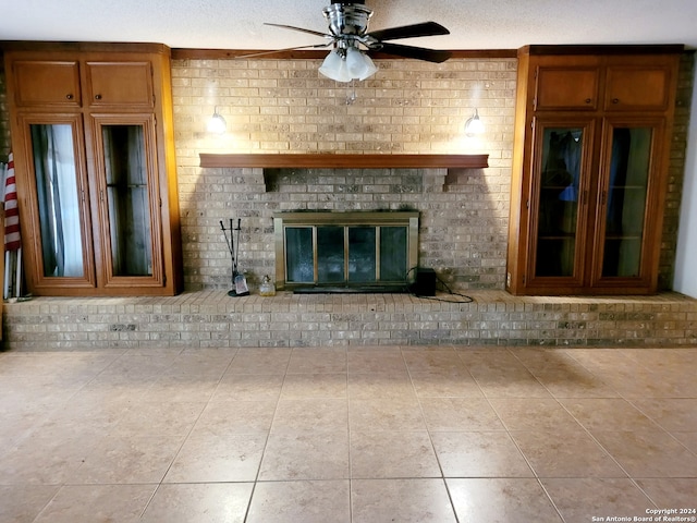 unfurnished living room featuring tile flooring, brick wall, and a fireplace