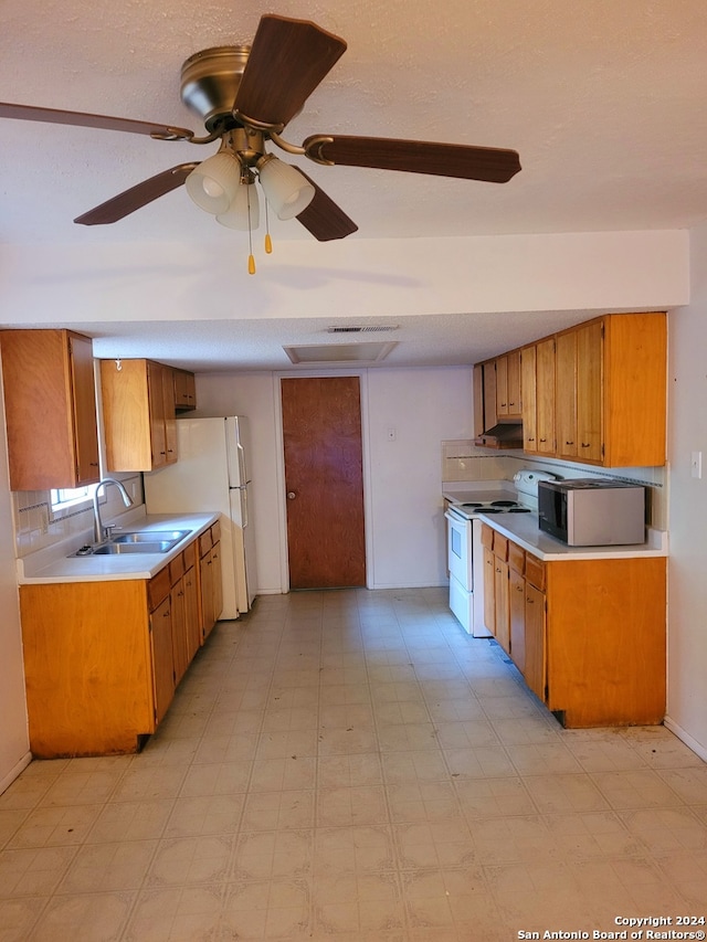 kitchen featuring light tile floors, white appliances, and sink