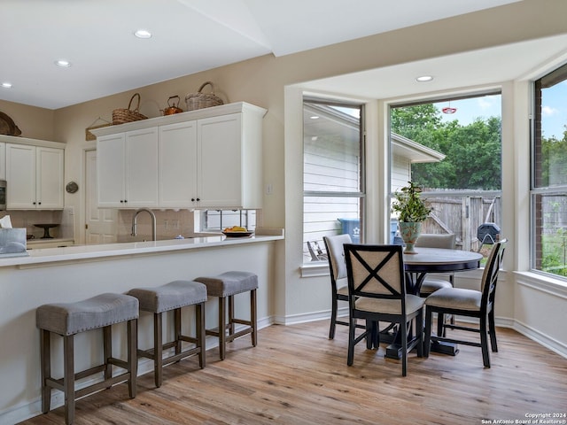 dining space featuring sink and light hardwood / wood-style floors