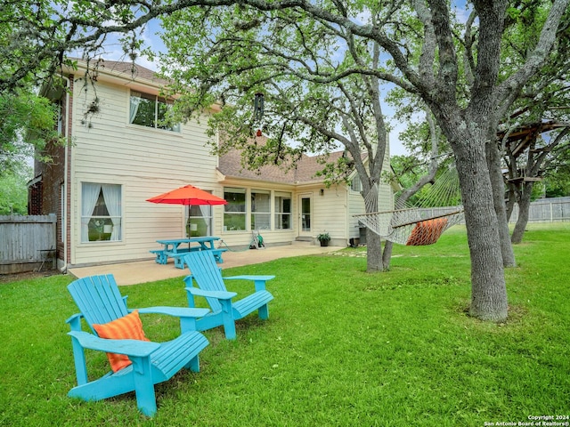 rear view of property with a patio area and a yard