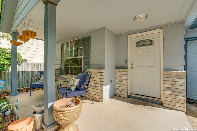 view of exterior entry featuring covered porch