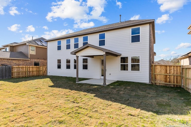 back of house featuring a lawn and a patio