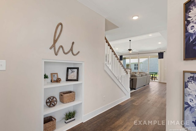 hall featuring dark hardwood / wood-style flooring and built in shelves