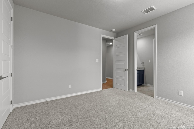 unfurnished bedroom featuring light carpet