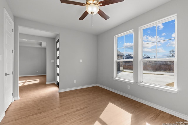 spare room with light wood-type flooring and ceiling fan