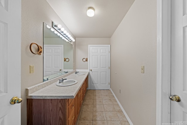 bathroom featuring dual vanity and tile floors