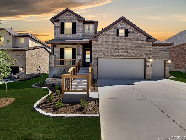 view of front of house featuring a garage and a yard