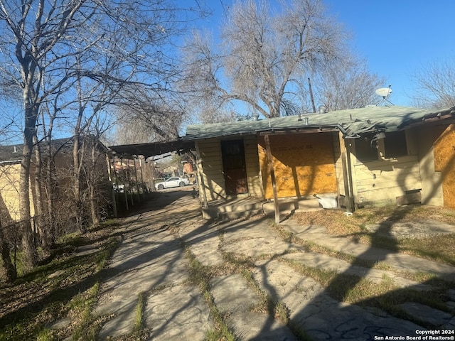 back of house with a carport