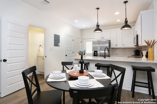 dining area with sink and hardwood / wood-style floors