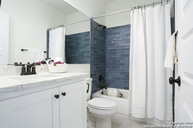 full bathroom with tile flooring, shower / tub combo, vanity, and toilet